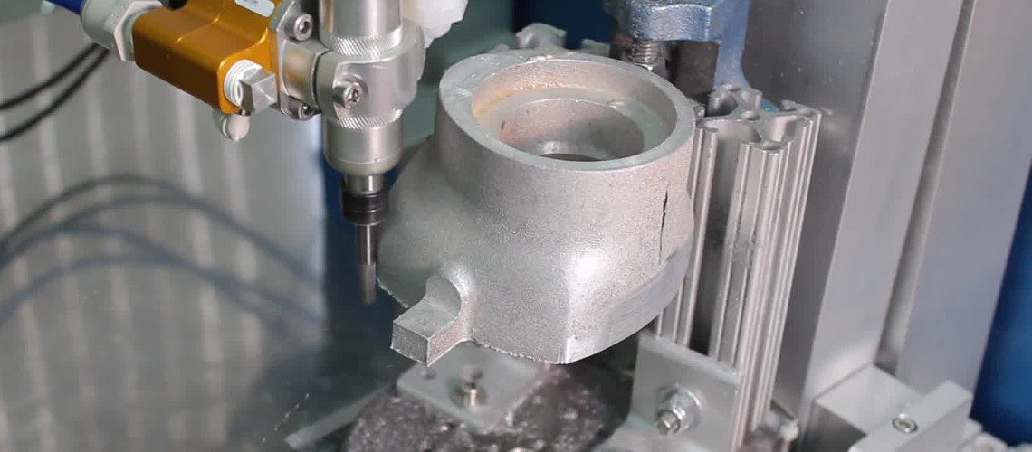 Robot removing flash from sand casting