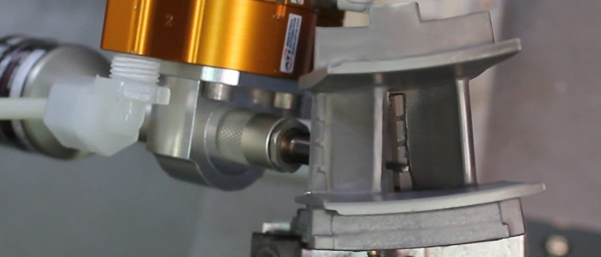 Robot with die grinder finishing a casting